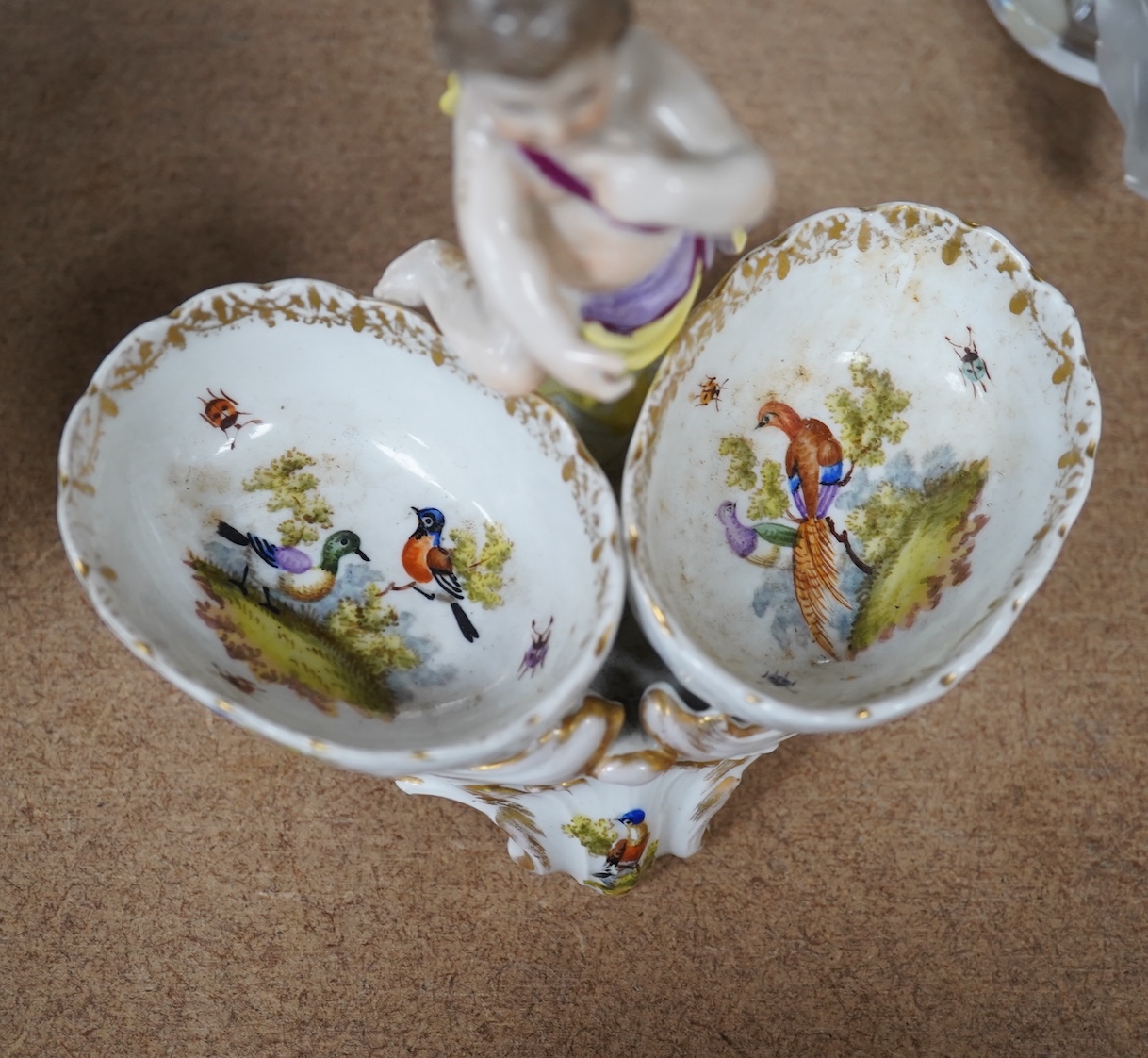 A pair of Berlin figural porcelain salts, hand painted with birds, 13.5cm wide. Condition - fair to good